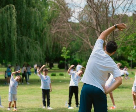 a group of people doing yoga in a park