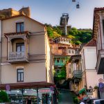 A charming view of Tbilisi's Old Town with its iconic wooden balconies and winding streets, captured on a warm May day
