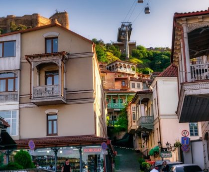 A charming view of Tbilisi's Old Town with its iconic wooden balconies and winding streets, captured on a warm May day