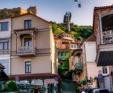 A charming view of Tbilisi's Old Town with its iconic wooden balconies and winding streets, captured on a warm May day