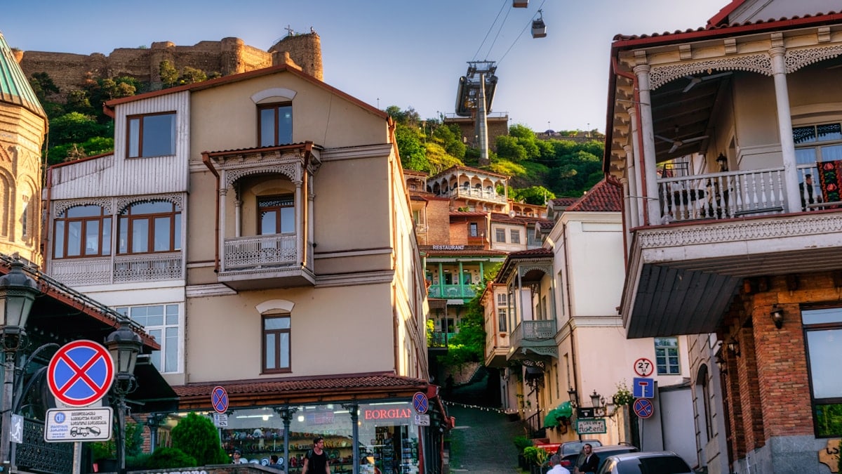 A charming view of Tbilisi's Old Town with its iconic wooden balconies and winding streets, captured on a warm May day